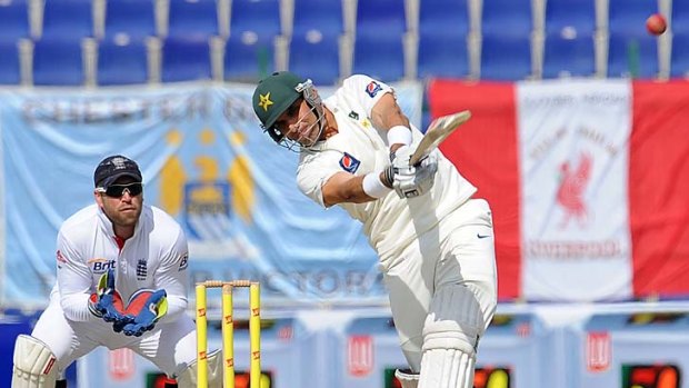 Misbah-ul Haq comes down the wicket to Monty Panesar as England wicketkeeper Matt Prior looks on at the Sheikh Zayed Stadium in Abu Dhabi.