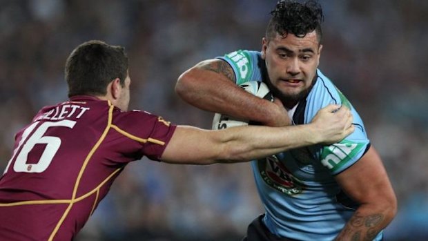 Unwanted: Andrew Fifita attempts to break a tackle in Origin III, 2013.