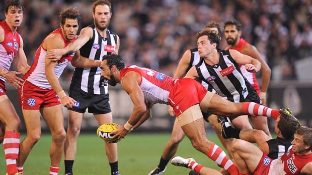 In charge: Adam Goodes looks to get the ball away.