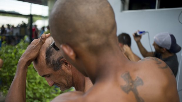 Cuban migrants set up a makeshift barber shop outside the immigration office in Penas Blancas. 