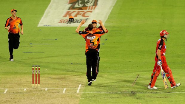 Jason Behrendorff and Tom Triffitt of the Scorchers celebrate the wicket of Ben Rohrer of the Renegades.