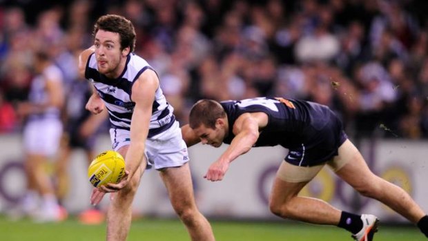 Geelong's Jesse Stringer is chased by Carlton's Aaron Joseph.