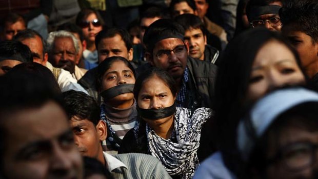 Women wear black bands across their face as they join a gathering mourning the death of a gang rape victim in New Delhi, India.
