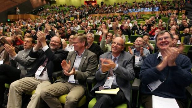 Physicists applaud the Higgs boson announcement in Melbourne.