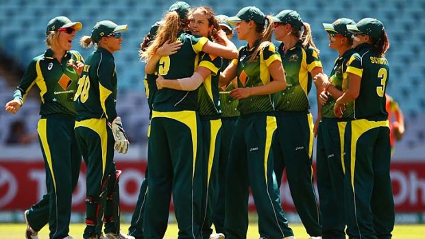 Rene Farrell is congratulated by her teammates after taking a wicket during game three of the Women's International Twenty20 series in Sydney on Sunday.