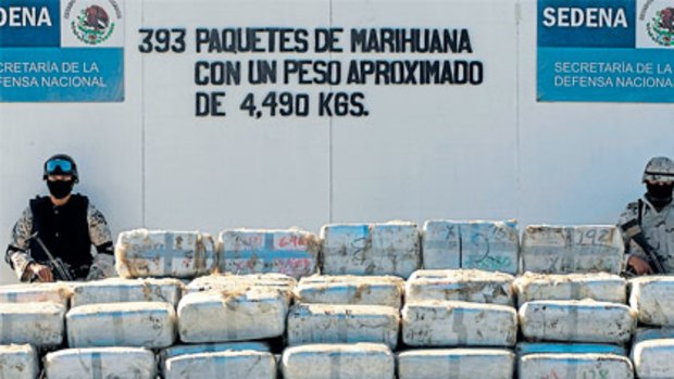Mexican soldiers guard tonnes of marijuana seized in a tunnel between Tijuana and San Diego.
