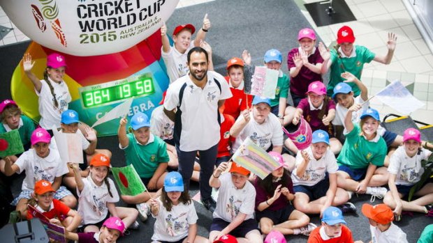Australian cricketer Fawad Ahmed students  with students Jerrabomberra Primary School on Friday at the launch of the 365-day countdown to the Cricket World Cup.