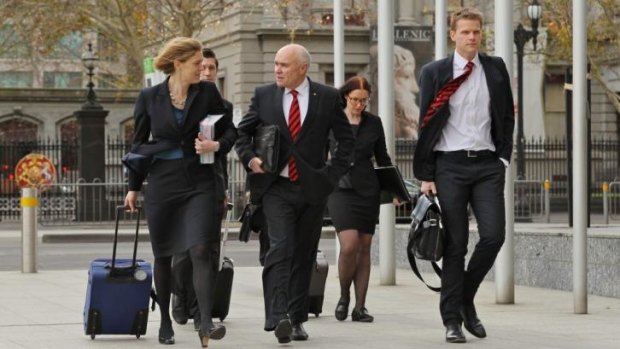 Essendon chairman Paul Little (centre) arrives at the Federal Court with the club's legal team.