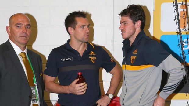Hawthorn chief executive Stuart Fox speaks to Luke Hodge and Isaac Smith in the rooms after the Hawks won the round 23 match against Carlton on Saturday.