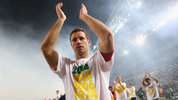 Leading man: Lucas Neill thanks fans at ANZ Stadium after the Socceroos qualified for Brazil with a hard-fought defeat of Iraq on Tuesday night.