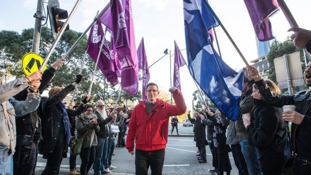 Roz Ward gives a clenched fist salute after returning to work at La Trobe University following controversy earlier this year.