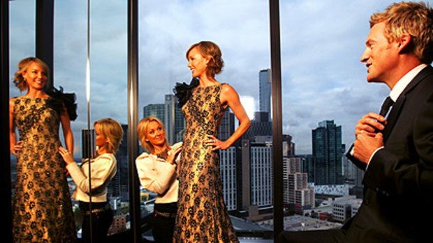 Channel Nine head stylist Cheryl Weir styles Elise Mooney, who wears a Mathieu Salem gown and Temelli jewellery, and Jules Lund, in a Dom Bagnato suit, at the Crown Metropol.