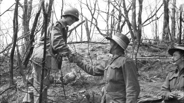Captain Reg Saunders shakes hands with a South Korean soldier in April 1951.      
