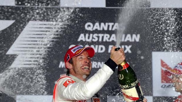 British world champion Jenson Button celebrates his Albert Park grand prix win after cruising home in his McLaren.
