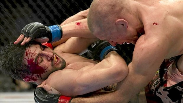 Carlos Condit, bottom, battles with Georges St-Pierre during their UFC welterweight title fight in Montreal.
