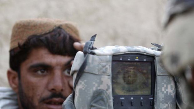 Look ahead ... a US soldier checks an Afghan's identity using a biometric scanner.