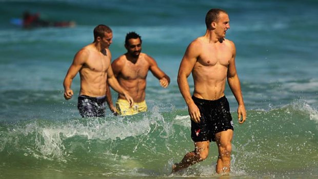 Like Swans to water ... Ted Richards, right, with his Sydney teammates at Bondi yesterday.