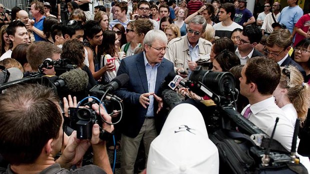 Kevin Rudd talks with the press during his walk through Queen Street Mall this afternoon.