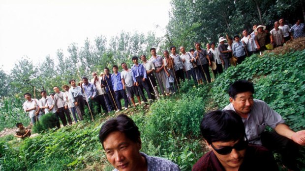 Blind activist lawyer Chen Guangcheng, with the sunglasses, is pictured in front of a group of disabled rural farmers in China.