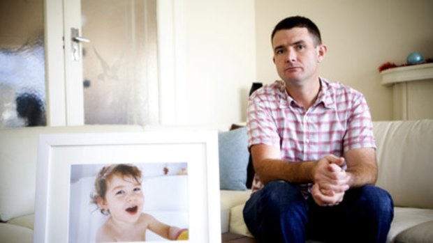 Cameron Harris with a photograph of his daughter, Lauren, who drowned in 2008.