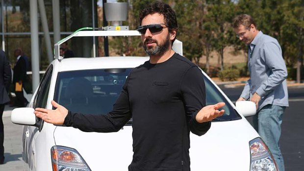 Sergey Brin in front of a Google self-driving car.