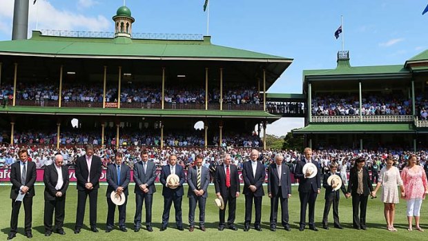 Members of the Greig family (R) and Channel Nine cricket commentary team (L) stand in silence to mark the passing of former England Test crickter and Channel Nine cricket commentator Tony Greig prior to day one of the Third Test.