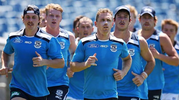 Mitch Duncan (left) and Joel Selwood lead the pack during Geelong's pre-season work at Skilled Stadium.
