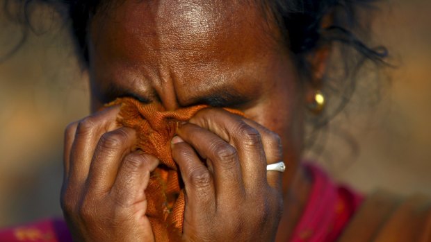 A woman mourns the death of a family member after the body was recovered from a collapsed house during the cremation ceremony, after Saturday's earthquake, in Bhaktapur, Nepal.