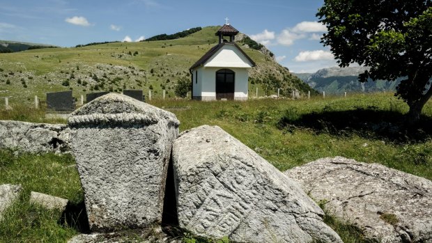 Stecci (medieval gravestones) and serbian-orthodox chapel in mountain village Blace, Serbia. Photo: Alamy