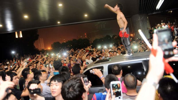 Angry Chinese fans protest after the national team's 5:1 defeat by Thailand on June 15.
