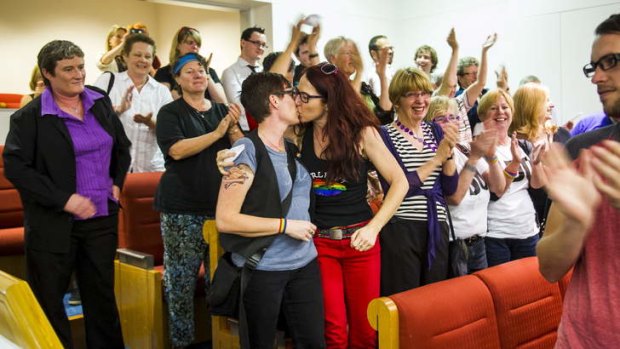 Julie Maynard and Frances Bodel, from Belconnen, celebrate in the public gallery after the same-sex bill is passed.