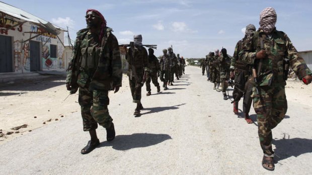 Driving people away: Al-Shabaab soldiers patrol the streets of Southern Mogadishu.