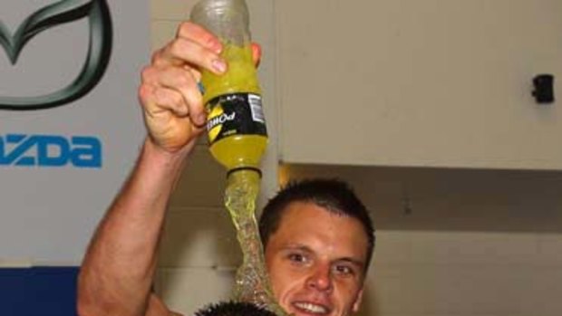 Kangaroo new boy Ryan Bastinac receives the traditional sports drink ''shower'' after the win over West Coast.