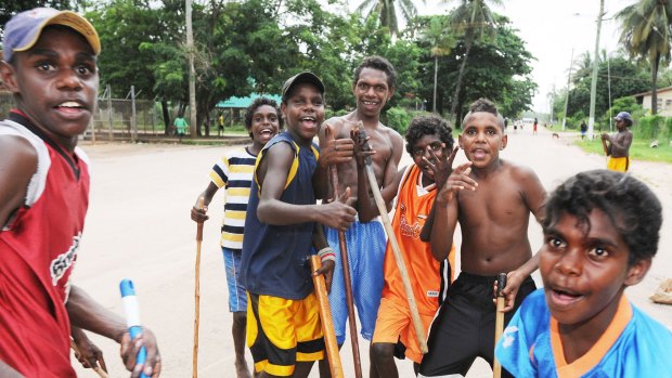 Going nowhere fast: At dusk, boys gather with their sticks to play.