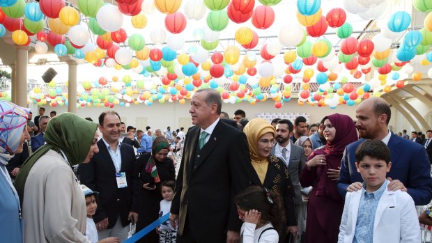 Recep Tayyip Erdogan, centre left, his wife Emine Erdogan, center, his son Bilal Erdogan, right, and other family members at a school ceremony in Istanbul, earlier this month.