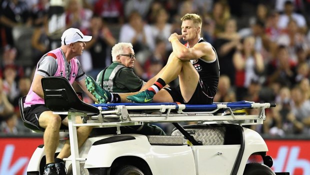 Initial fears: Nick Riewoldt is stretchered off the ground.