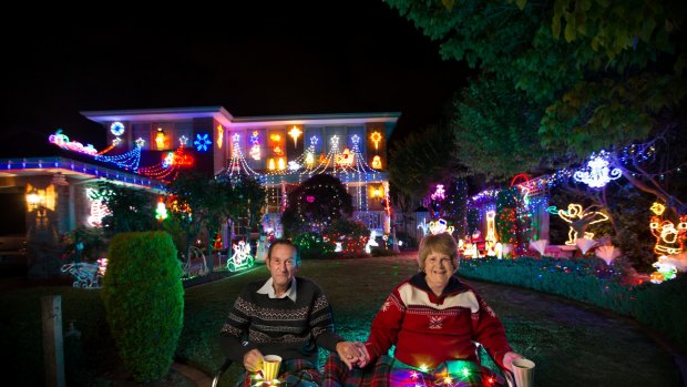 Reg and Gale Ford from Wantirna enjoy a cuppa in front of their festooned home.