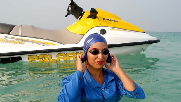 A place to relax ... an Iranian woman emerges from the water after riding a jetski at Kish Island.
