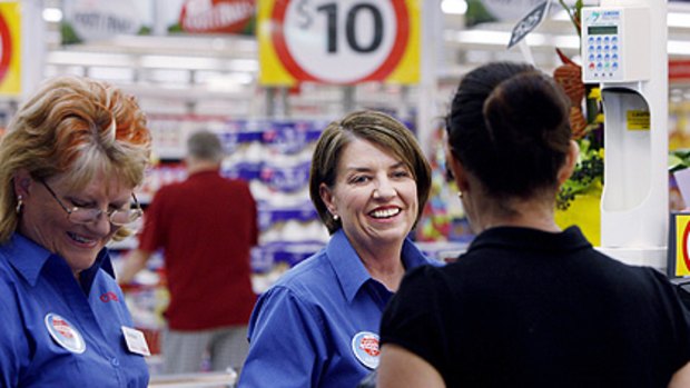 Check it out ... Queensland Premier Anna Bligh (centre) shadows mum-of-four Christine Howcroft during a shift at Coles.