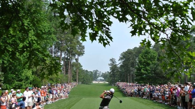 On course  ... Rory McIlroy hits a tee shot during a practice round at Augusta this week.