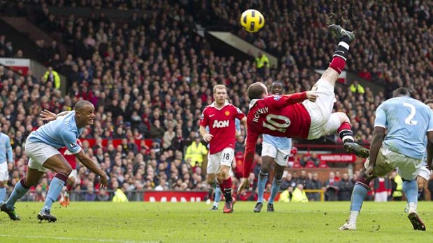 Manchester United's Wayne Rooney, center right, scores the winning goal with an overhead kick against Manchester City, Saturday, Feb. 12, 2011.