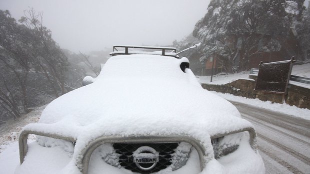 A four-wheel-drive covered with snow after an overnight dump at Mount Buller.