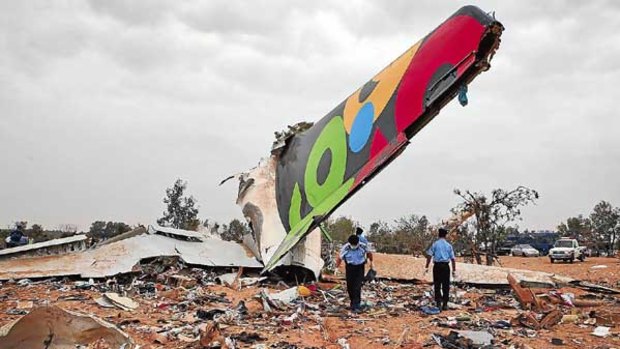 Rescue teams search the site of the Libyan Afriqiyah Airways plane crash in Tripoli.