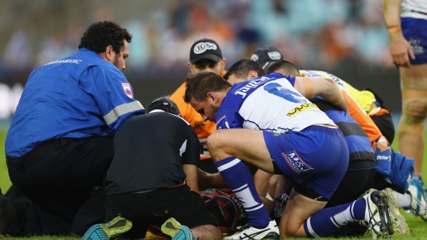 Distressed state: Robbie Farah is attended to before being stretchered off the field.