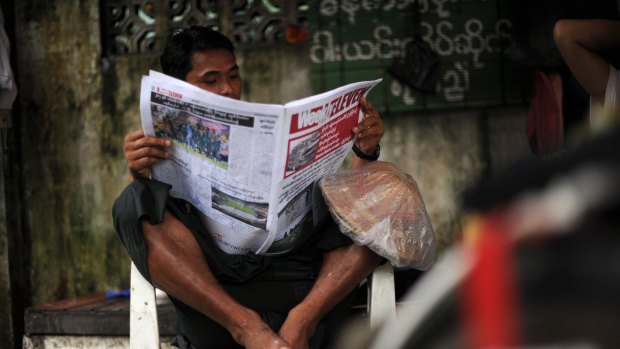 A Myanmar man reads a local newspaper in Yangon.