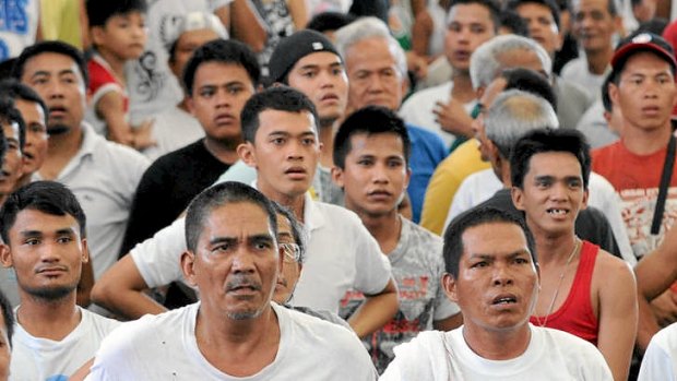 Filipino spectators are stunned as they watch a live broadcast of boxer Manny Pacquiao hitting the canvas to lose his non-title bout in Las Vegas.