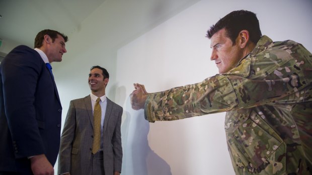 Artist Michael Zavros, right, with one of two portraits of Ben Roberts-Smith VC, MG, left, at the Australian War Memorial.
The Canberra Times