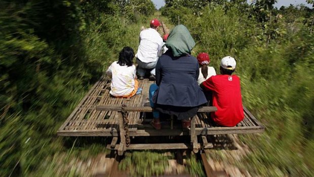 Link: Cambodians ride a bamboo train on a reopened stretch of line.