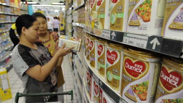 Shoppers in China study milk powder labels after the Fonterra scare came to light last year.