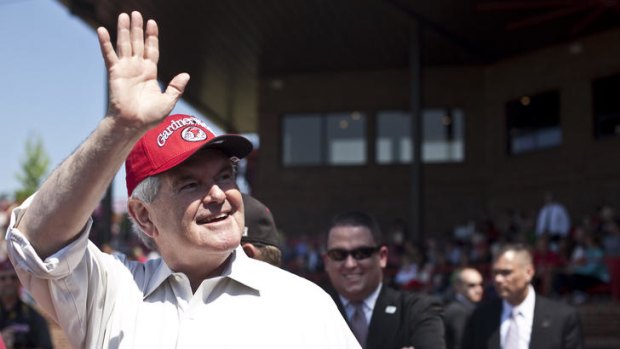 Newt Gingrich waves to the crowd prior to throwing out the first pitch at a baseball game.